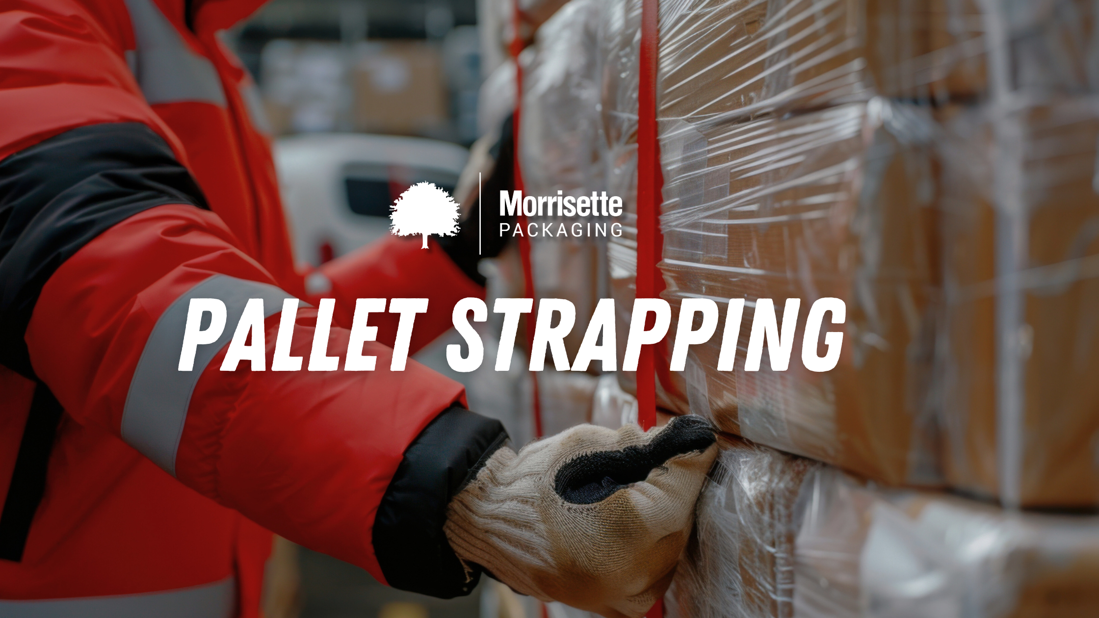 a worker using pallet strapping to secure a load of packaging